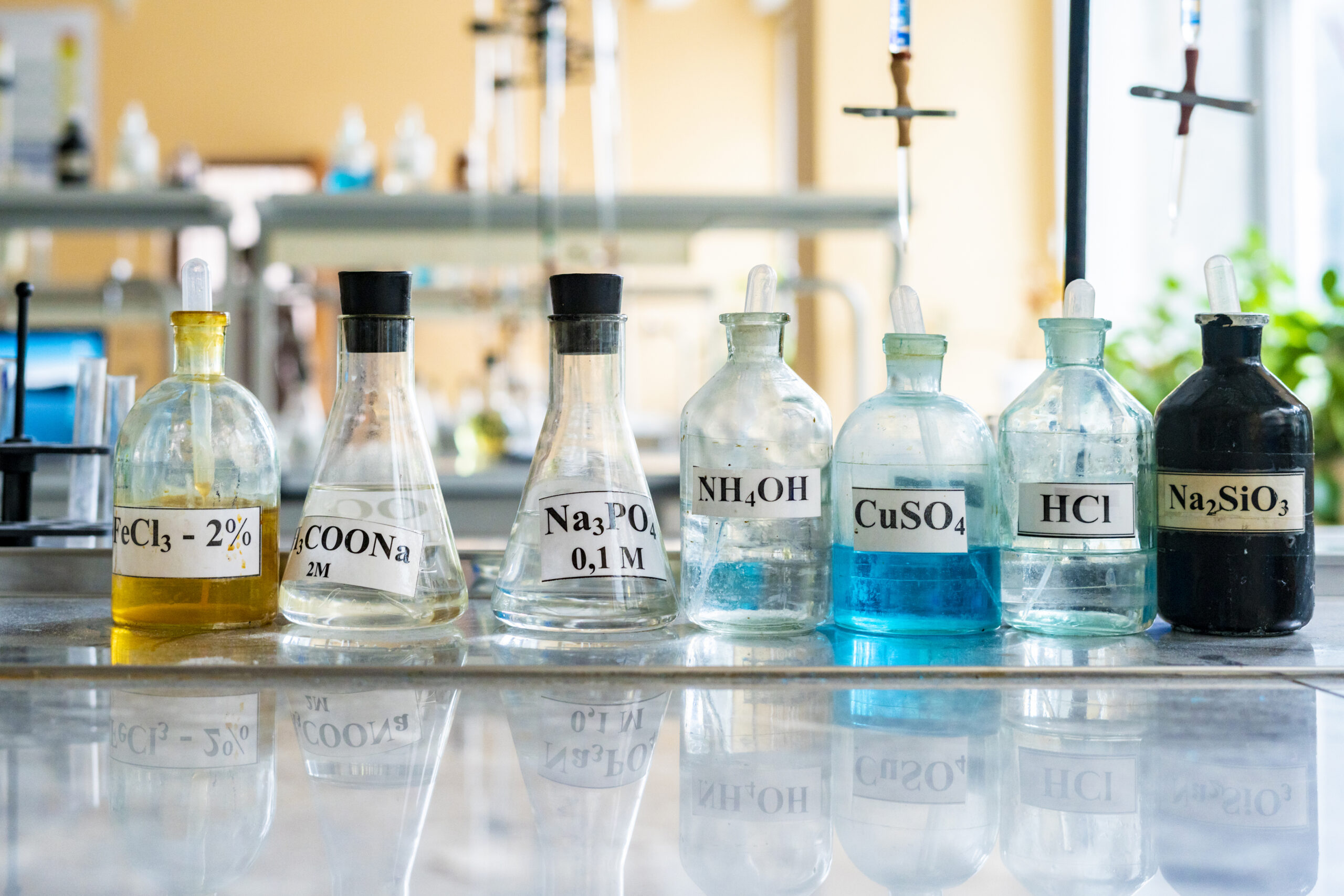 chemical flasks with acid stand in laboratory